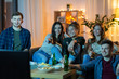 © Syda Productions - friendship, and leisure concept - happy friends with non-alcoholic drinks and snacks watching tv at home in evening
