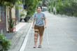 © mkitina4 - Disabled woman with crutches or walking stick or knee support standing with full lenght body.