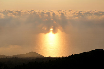 Sea, sky, beautiful structure of clouds, majestic landscape with seascape at calm sunset on horizon of mediterranean coast. Amazing sunset vibes on edge ocean. Sunrise over sea, natural environment.