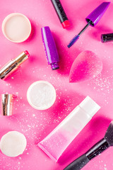 Various make up cosmetic set bright pink background copy space flatlay above