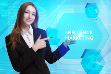 The concept of business, technology, the Internet and the network. A young entrepreneur working on a virtual screen of the future and sees the inscription: Influence marketing