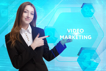 The concept of business, technology, the Internet and the network. A young entrepreneur working on a virtual screen of the future and sees the inscription: Video marketing