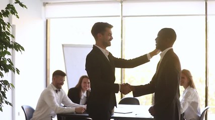 Wall Mural - proud happy african employee get promoted rewarded by manager handshake