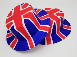 two top hats painted with the british union jack flag colours of red white and blue brexit 