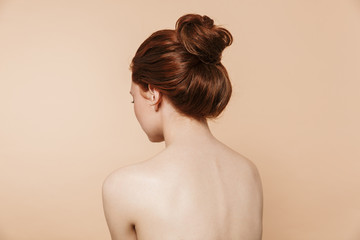 Back view photo of a young redhead woman