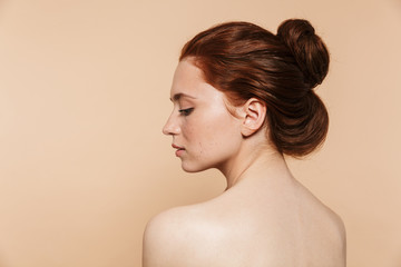 Back view photo of a young redhead woman