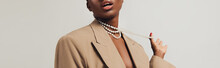 Cropped View Of Seductive African American Woman In Beige Jacket And Necklace Isolated On Grey