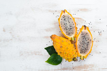 Yellow Dragon Fruit On A White Wooden Background. Pitahaya Tropical Fruits. Top View. Free Space For Text.