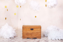 Modern Vintage Interior Of Children's Room With An Old Wooden Chest On The Background Of A Textured Wall With Clouds. Children's Playground For Photo Shoots. Chest For Toys And Games For Children.