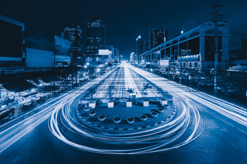 Aufkleber - Car lights with U turn road in Sutthisan district with architecture buildings in transportation concept. Urban city, Bangkok at night, Thailand.