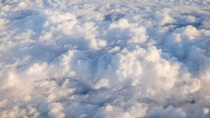 Wall Mural - The beautiful cloudscape with clear blue sky. A view from airplane window.