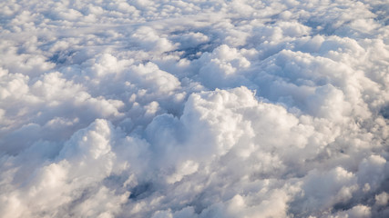 Wall Mural - The beautiful cloudscape with clear blue sky. A view from airplane window.