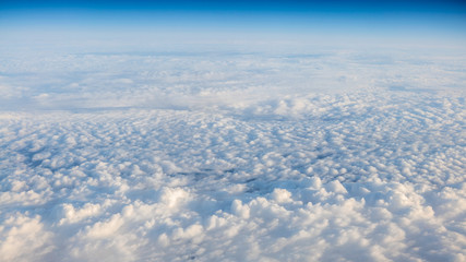 Wall Mural - The beautiful cloudscape with clear blue sky. A view from airplane window.