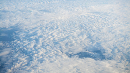 Wall Mural - The beautiful cloudscape with clear blue sky. A view from airplane window.