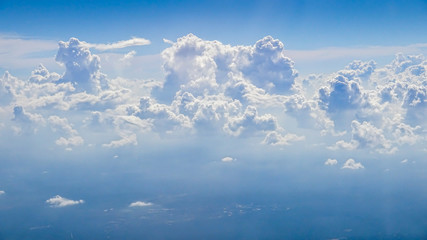 Wall Mural - The beautiful cloudscape with clear blue sky. A view from airplane window.