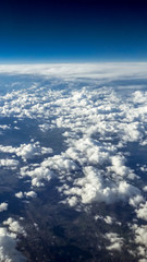 Wall Mural - The beautiful cloudscape with clear blue sky. A view from airplane window.