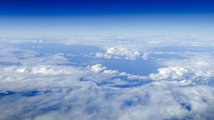 Wall Mural - Wonderful view of cloudscape with clear blue sky from above.