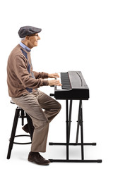 Wall Mural - Elderly man playing a digital piano