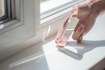 Transparent prism for light education expriments in a man's'hand