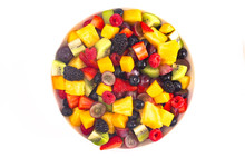 Bowl Of Rainbow Colored Fruit Salad Isolated On A White Background