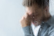 © LIGHTFIELD STUDIOS - selective focus of crying man behind wet window