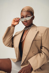 Wall Mural - attractive fashionable african american girl posing in sunglasses and beige jacket isolated on grey