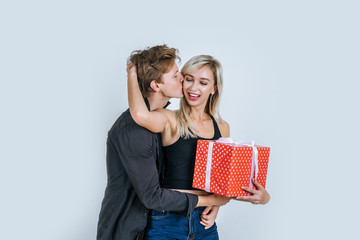 Portrait of happy young couple love together surprise with gift box in studio