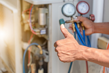 Close up of Air Conditioning Repair, repairman on the floor fixing air conditioning system