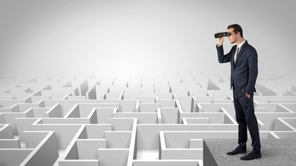 Wall Mural - businessman standing on maze and looking forward to the future concept
