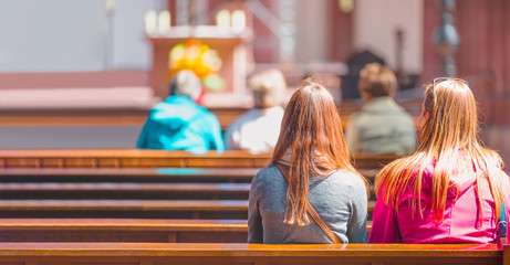  People praying in a church - Blurred photo inside of a church 