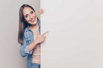 Portrait of her she nice attractive lovely shine cheerful cheery positive straight-haired lady pointing forefinger at big large promotion ad advert isolated over light white gray background