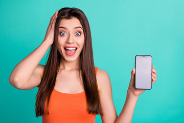 Wall Mural - Portrait funny funky lady astonished impressed news novelty modern technology decision choice advert advise display long hairdo touch head palm yell expression  youth clothes isolated teal background