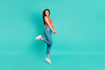 Poster - Full length side profile body size photo beautiful her she lady jump high amazed excited unexpected weekend vacation wear casual orange tank-top jeans denim isolated bright teal turquoise background