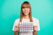 Close up photo amazing beautiful she her lady arms hands hold paper calendar not happy oh no expression miss few days vacation weekend wear specs casual white t-shirt isolated teal green background