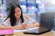 © manit - Portrait of young asian female student working with her laptop.