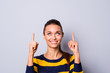 © deagreez - Portrait of cute excited charming nice lady youth feel positive cheerful advertise choose decide option promo feedback recommend toothy content isolated wear fashionable nice clothing grey background