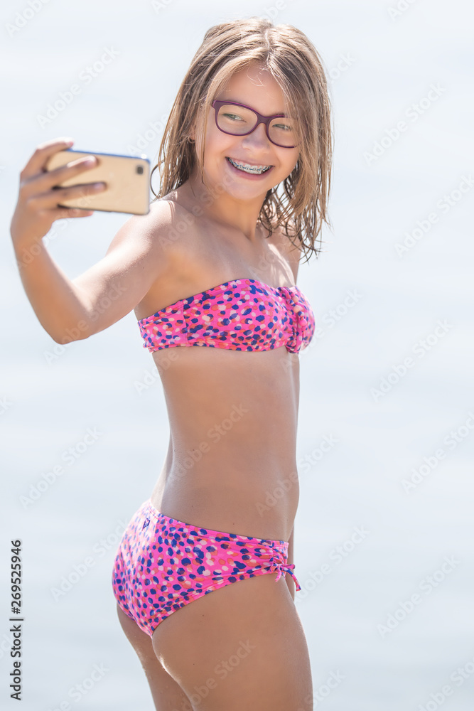 young girl pictures Happy young girl with dental braces making selfhie on beach in summer hot day の Stock フォト | Adobe Stock