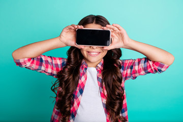 Poster - Close-up portrait of her she nice attractive cheerful cheery playful wavy-haired girl in checked shirt closing eyes with new cool device isolated on bright vivid shine green blue turquoise background