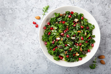 Wall Mural - fresh kale, roasted chickpeas, almond and pomegranate salad in white bowl