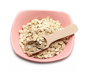 Oats, rye grain cereal for breakfast in bowl with wooden spoon isolated on white background