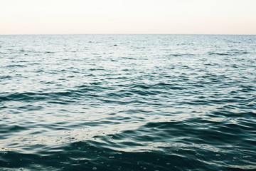 Wall Mural - Beautiful sea waves surface close up from beach. Blue waves in ocean in evening time. Tranquil calm moment. Summer vacation. Copy space