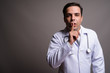 © Ranta Images - Handsome Persian man doctor against gray background