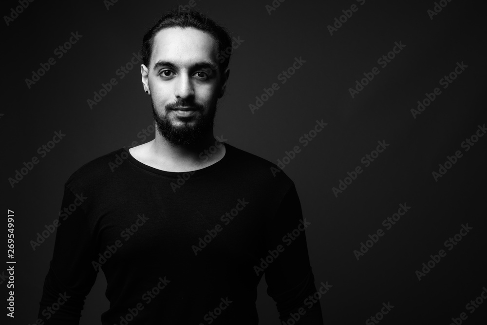 Young bearded Indian man in black and white - obrazy, fototapety, plakaty 