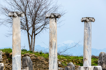 Marble columns on a background of mountains in the Ancient city of Perge near Antalya, Turkey