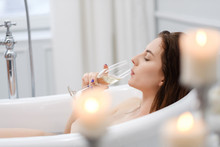 Woman Laying In A Bath With Glass Of Champagne