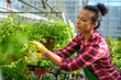© Nejron Photo - Black woman working in a botanical garden