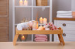 © New Africa - Composition with candles, flowers and stones on wooden table in spa salon