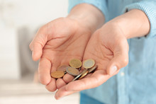 Man Holding Coins In Hands Indoors, Closeup