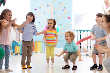 group of happy children jumping indoor. kids play together