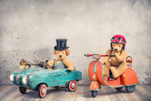 Teddy Bear In Antique Cylinder Hat Driving Rusty Retro Toy Pedal Car From Circa 60s And Teddy Bear In Red Helmet With Goggles Sitting On Old Orange Children's Scooter. Vintage Style Filtered Photo